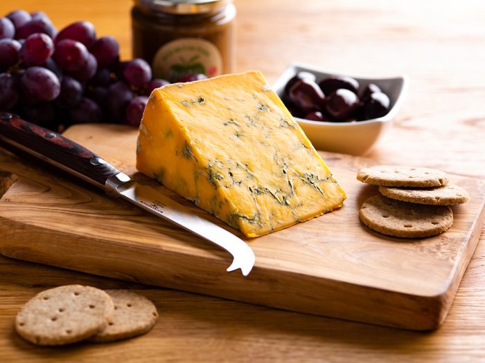 Shropshire blue cheese wedge on cheese board