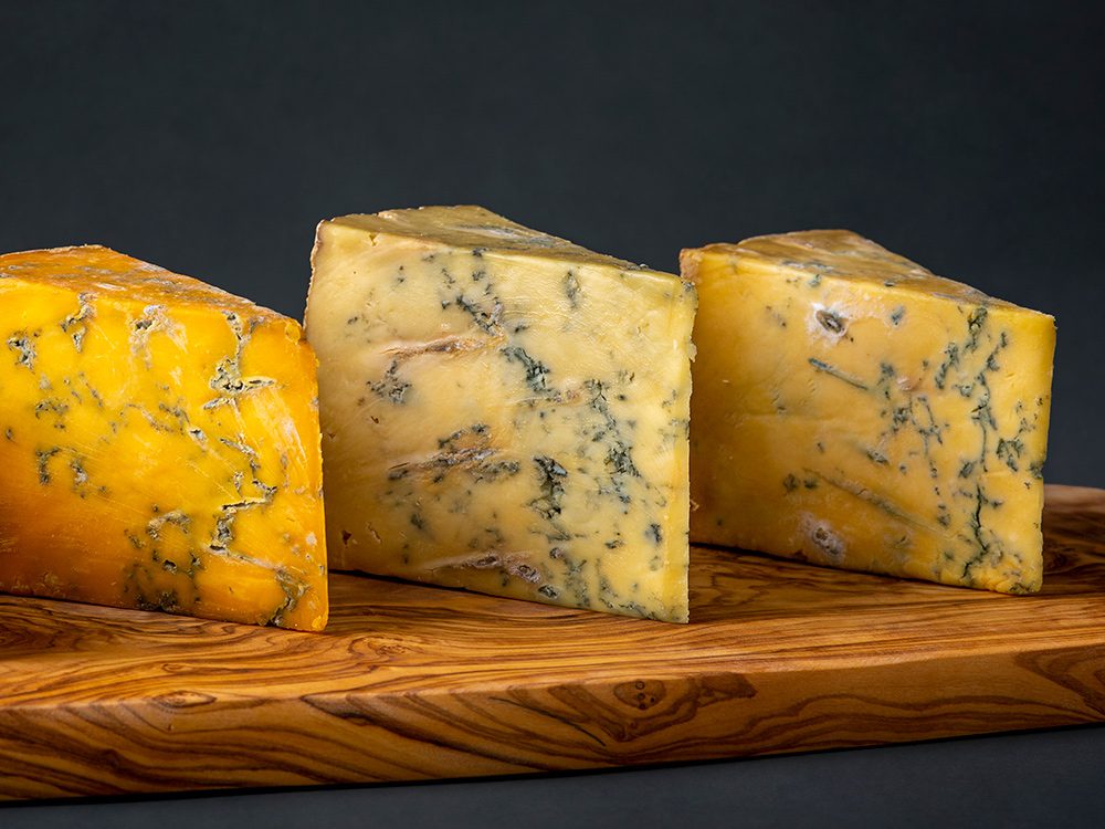 3 cheese wedges on cheese board