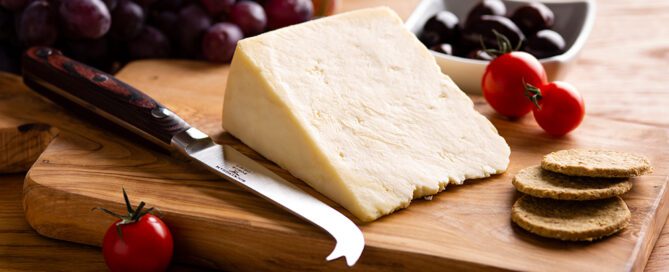 White Stilton cheese wedge on cheese board