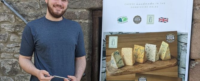 Ryan in front of a Hartington Creamery banner