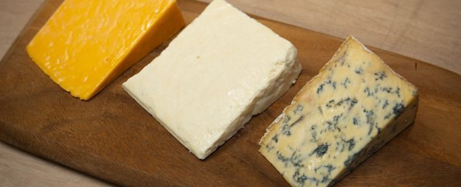 red white and blue cheese selection on a board